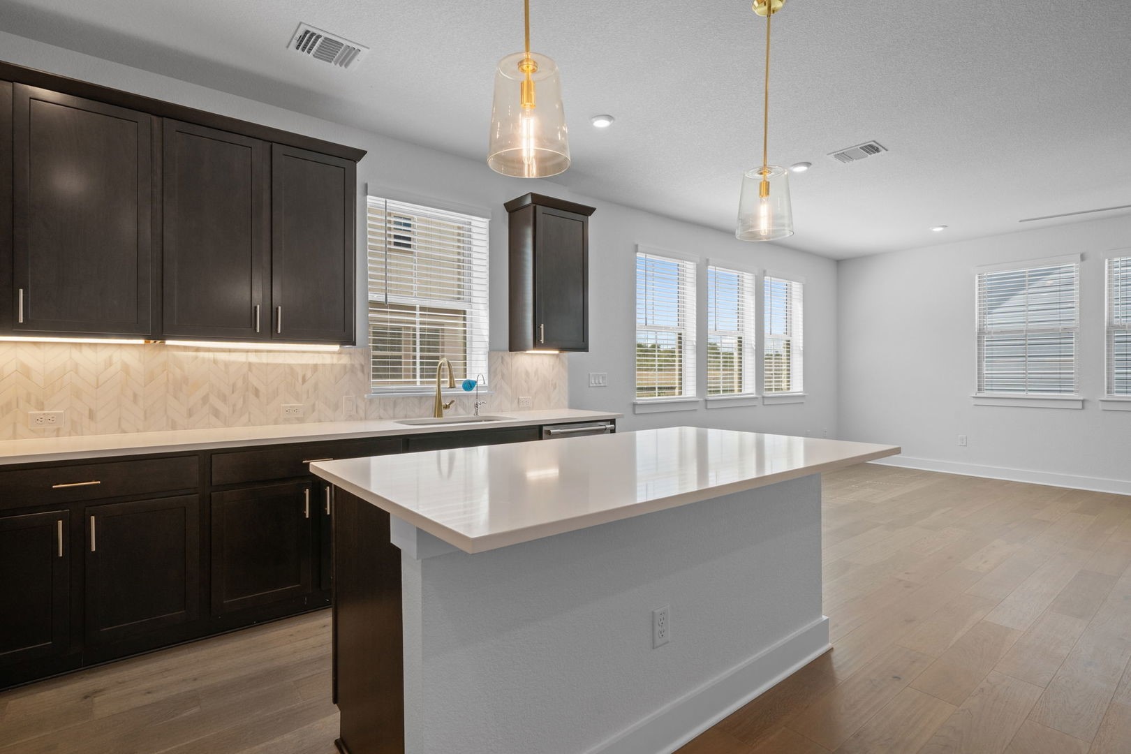6312 Stockman Drive, Unit 5 Austin, TX 78747 - Photo 13 of 40 a large kitchen with kitchen island a large counter space windows and a sink