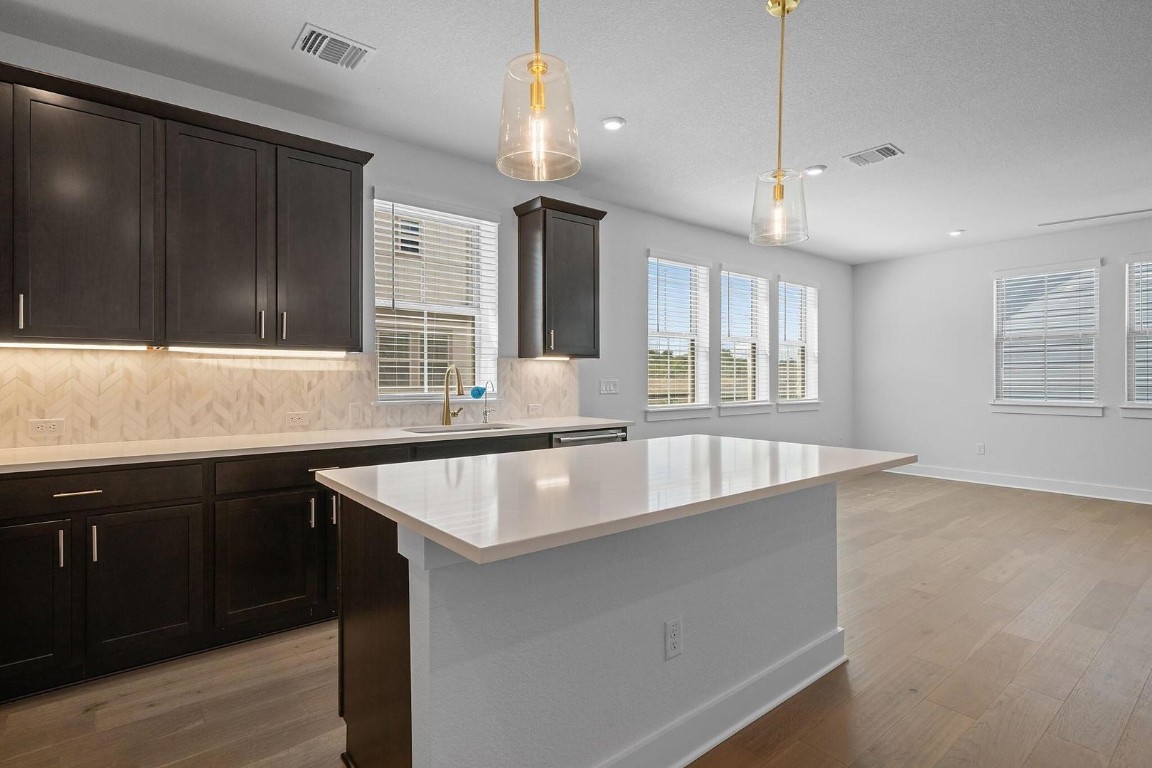 6312 Stockman Drive, Unit 5 Austin, TX 78747 - Photo 2 of 40 a large kitchen with kitchen island a large window and stainless steel appliances