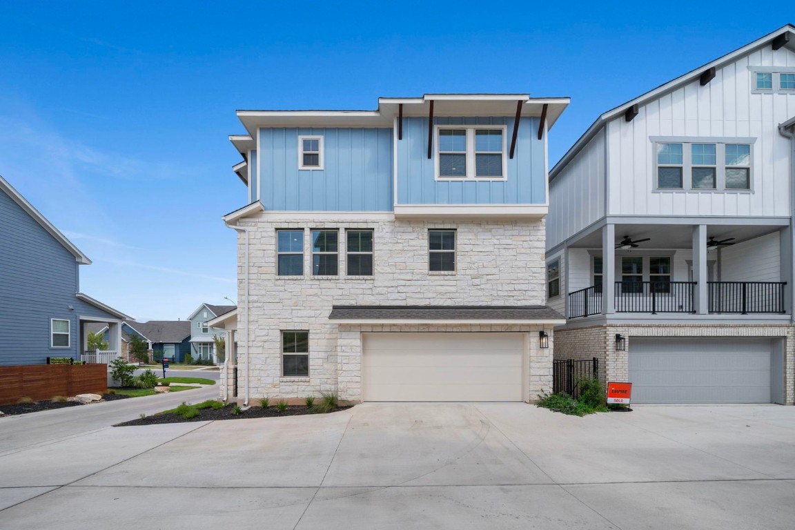 6312 Stockman Drive, Unit 5 Austin, TX 78747 - Photo 3 of 40 a front view of a house with a yard and garage
