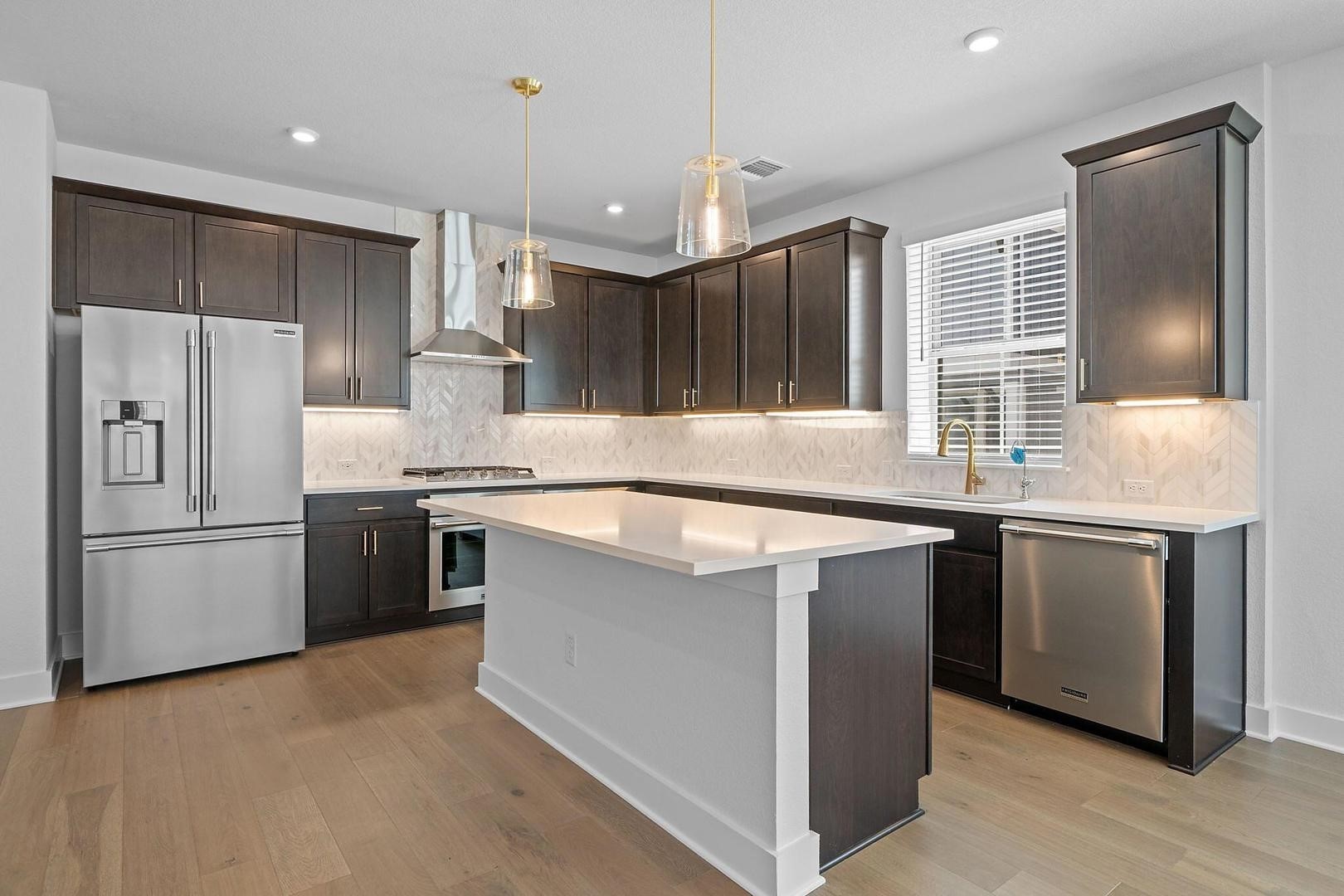 6312 Stockman Drive, Unit 5 Austin, TX 78747 - Photo 5 of 40 a kitchen with kitchen island a counter top space stainless steel appliances and cabinets