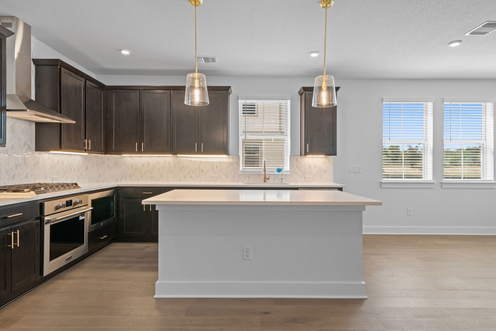 6312 Stockman Drive, Unit 5 Austin, TX 78747 - Photo 7 of 40 a kitchen with kitchen island a large counter top space a sink stainless steel appliances and cabinets