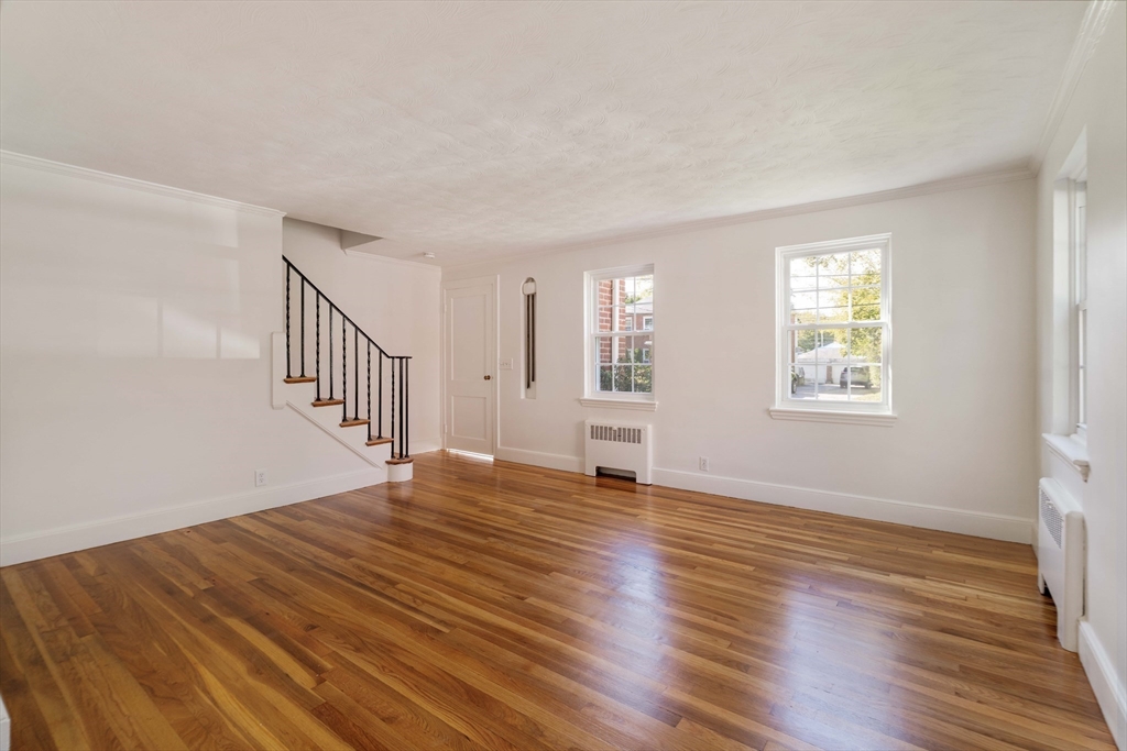 27 Payne Road, Unit 1 Newton, MA 02461 - Photo 11 of 18 a view of an empty room with wooden floor and window