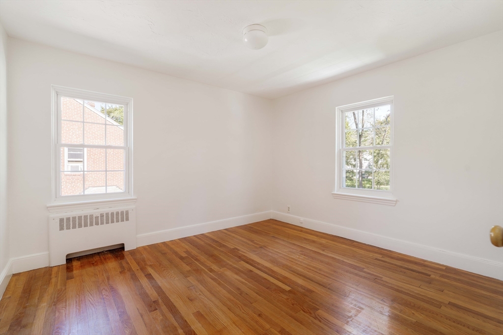 27 Payne Road, Unit 1 Newton, MA 02461 - Photo 14 of 18 an empty room with wooden floor and windows
