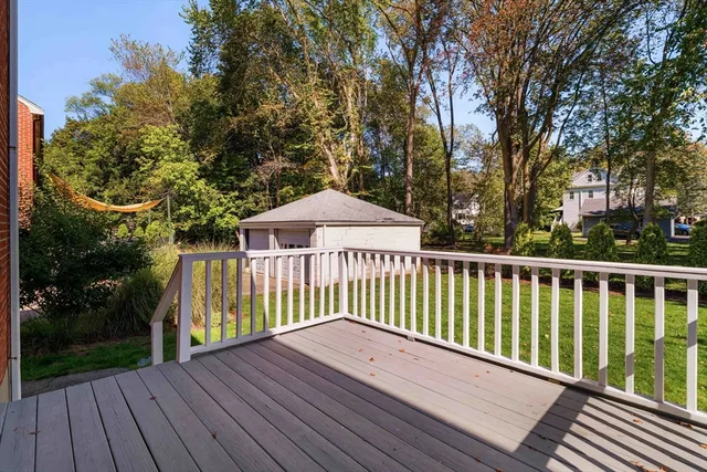 a view of wooden balcony and trees