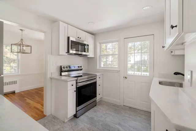 a kitchen with stainless steel appliances granite countertop a sink stove and microwave