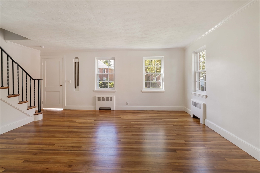 27 Payne Road, Unit 1 Newton, MA 02461 - Photo 9 of 18 a view of an empty room with window and wooden floor