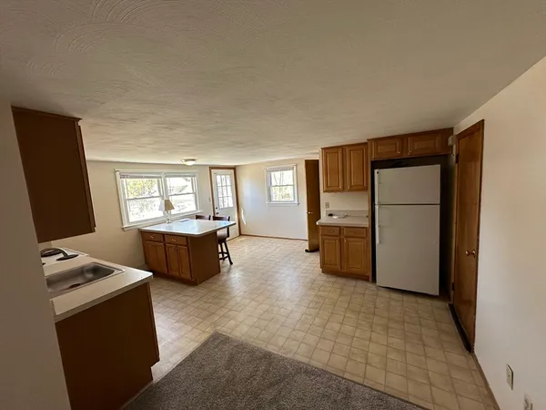 a kitchen with stainless steel appliances a refrigerator and a stove top oven