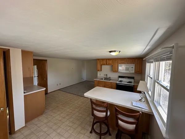 a kitchen with stainless steel appliances a refrigerator and a stove top oven