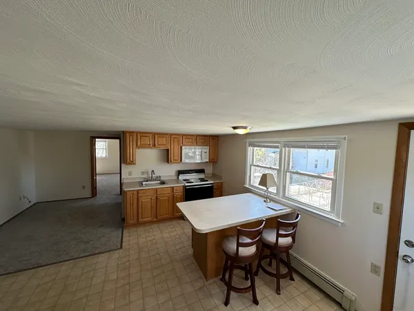 a kitchen with a table and chairs in it