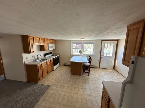 a living room with furniture a window and a table
