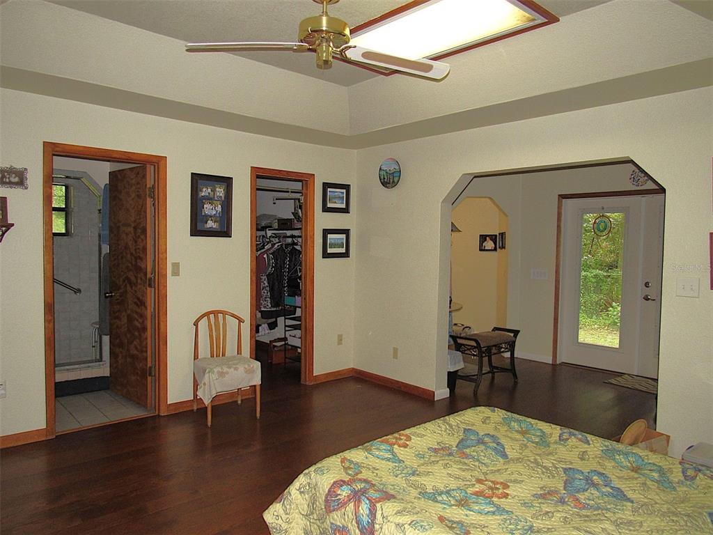 Undisclosed Address Reddick, FL 32686 - Photo 16 of 43 a bedroom with a bed and wooden floor