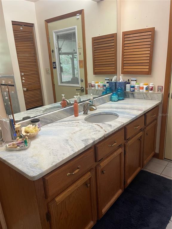 Undisclosed Address Reddick, FL 32686 - Photo 23 of 43 a bathroom with a granite countertop sink and a large mirror