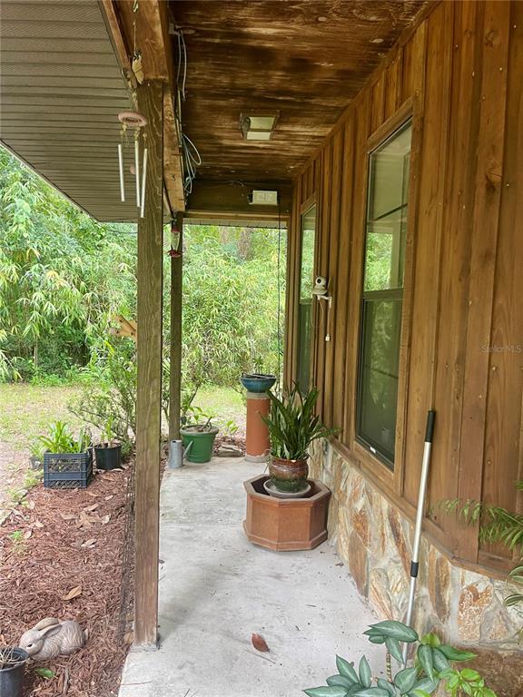 Undisclosed Address Reddick, FL 32686 - Photo 3 of 43 a view of a porch with chairs and backyard