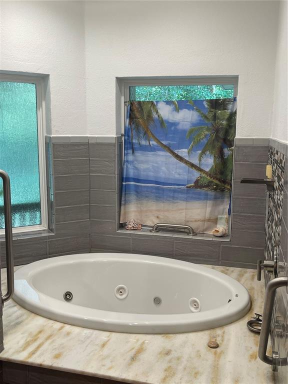 Undisclosed Address Reddick, FL 32686 - Photo 32 of 43 a bathroom with a tub and a shower