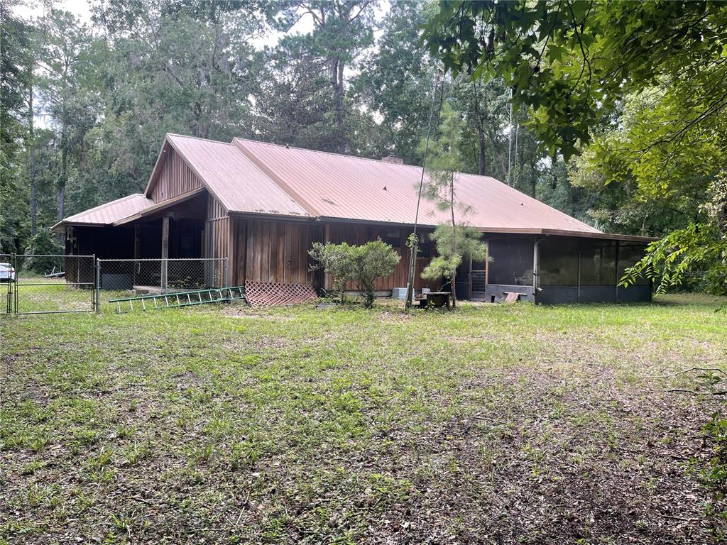 Undisclosed Address Reddick, FL 32686 - Photo 39 of 43 a view of house with backyard and outdoor seating