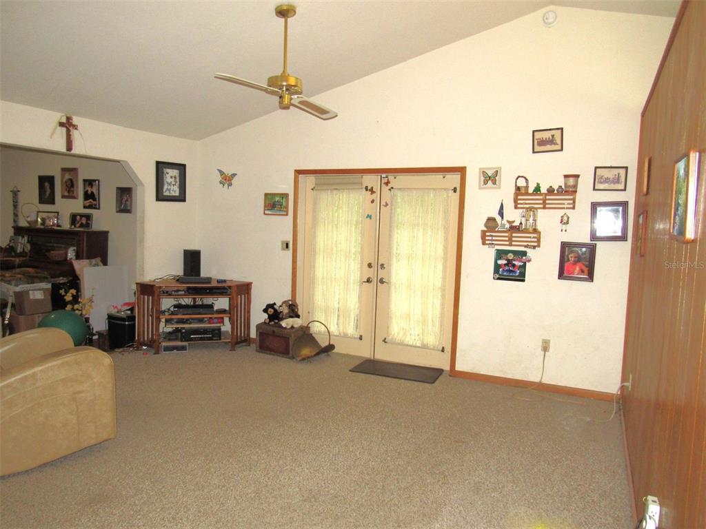 Undisclosed Address Reddick, FL 32686 - Photo 8 of 43 a living room with furniture and a flat screen tv
