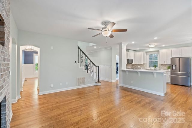 a view of a kitchen with wooden floor and a kitchen
