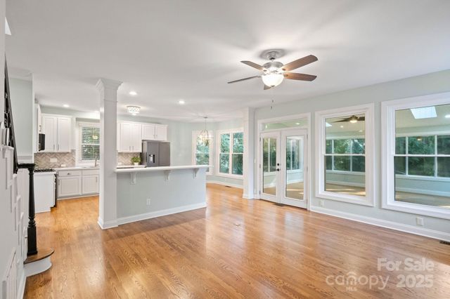 a view of a living room and kitchen with a large window