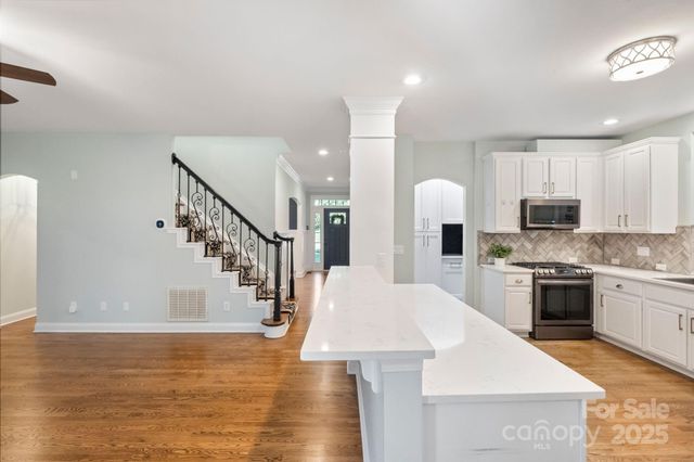 a view of kitchen with sink microwave and stove