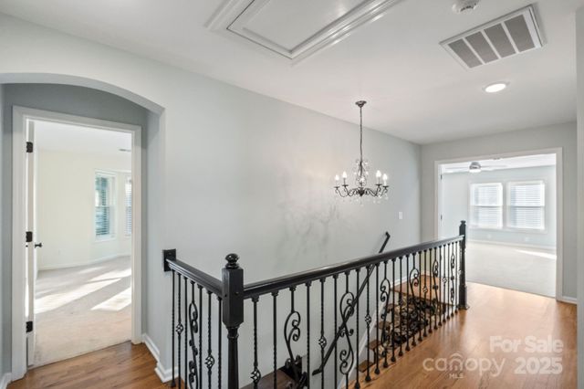 a view of a hallway view with wooden floor and staircase