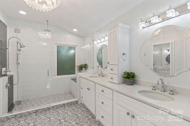 a spacious bathroom with a double vanity sink mirror and shower