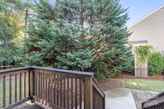 a view of a wooden fence and trees