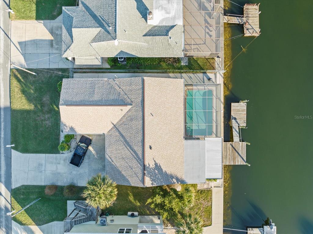an aerial view of houses with backyard