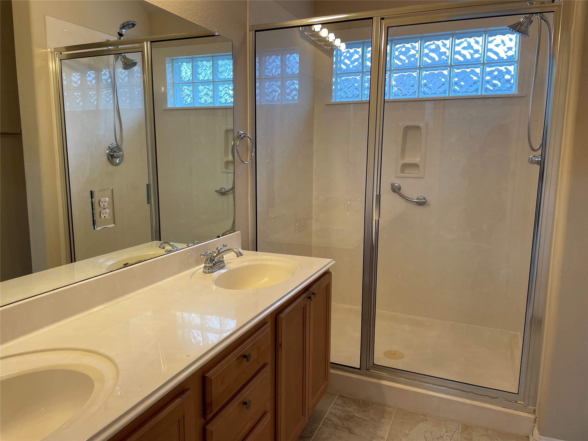 11713 Dunblane Way Austin, TX 78754 - Photo 14 of 22 Double vanity featuring integrated sinks and wood-finish cabinetry