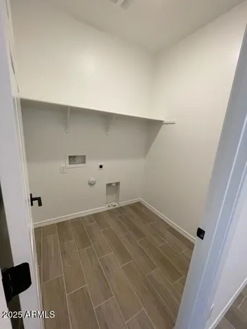 an empty room with wooden floor and cabinet