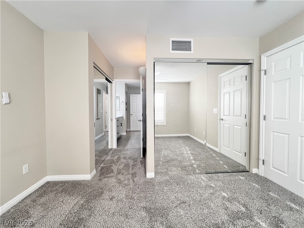 8070 West Russell Road, Unit 2070 Las Vegas, NV 89113 - Photo 5 of 25 Primary bedroom with two closets with mirror doors