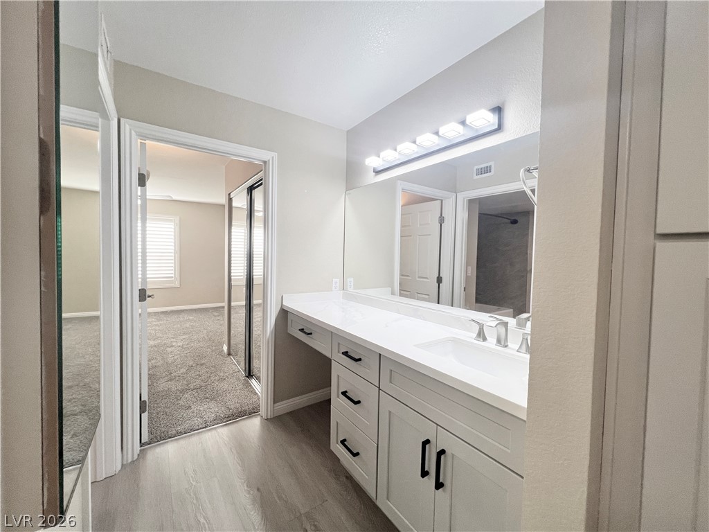 8070 West Russell Road, Unit 2070 Las Vegas, NV 89113 - Photo 6 of 25 Bathroom and hallway to primary bedroom