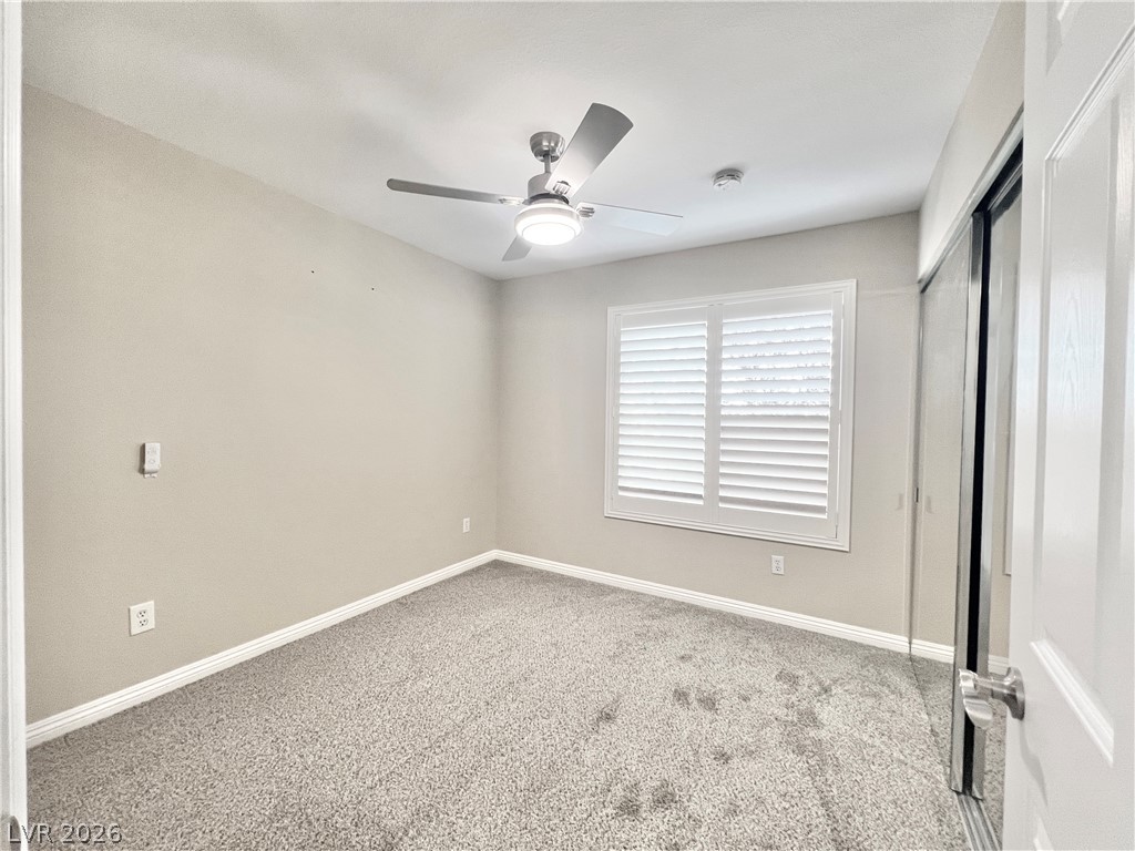 8070 West Russell Road, Unit 2070 Las Vegas, NV 89113 - Photo 10 of 25 2nd Bedroom with brand new carpet and contemporary ceiling fan with LED light
