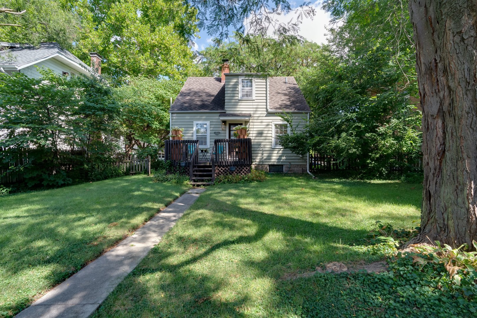 32 White Place Bloomington, IL 61701 - Photo 23 of 26 a view of a house with a big yard potted plants and large tree