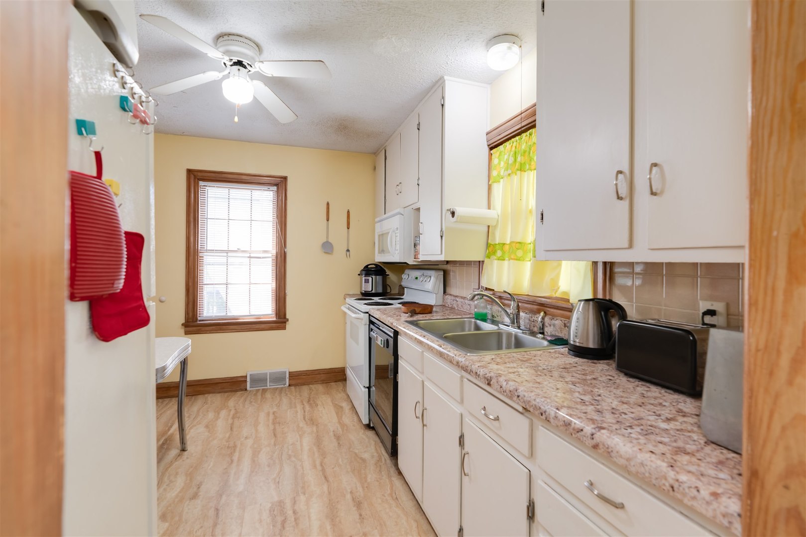 32 White Place Bloomington, IL 61701 - Photo 7 of 26 a kitchen with a sink appliances cabinets and a window