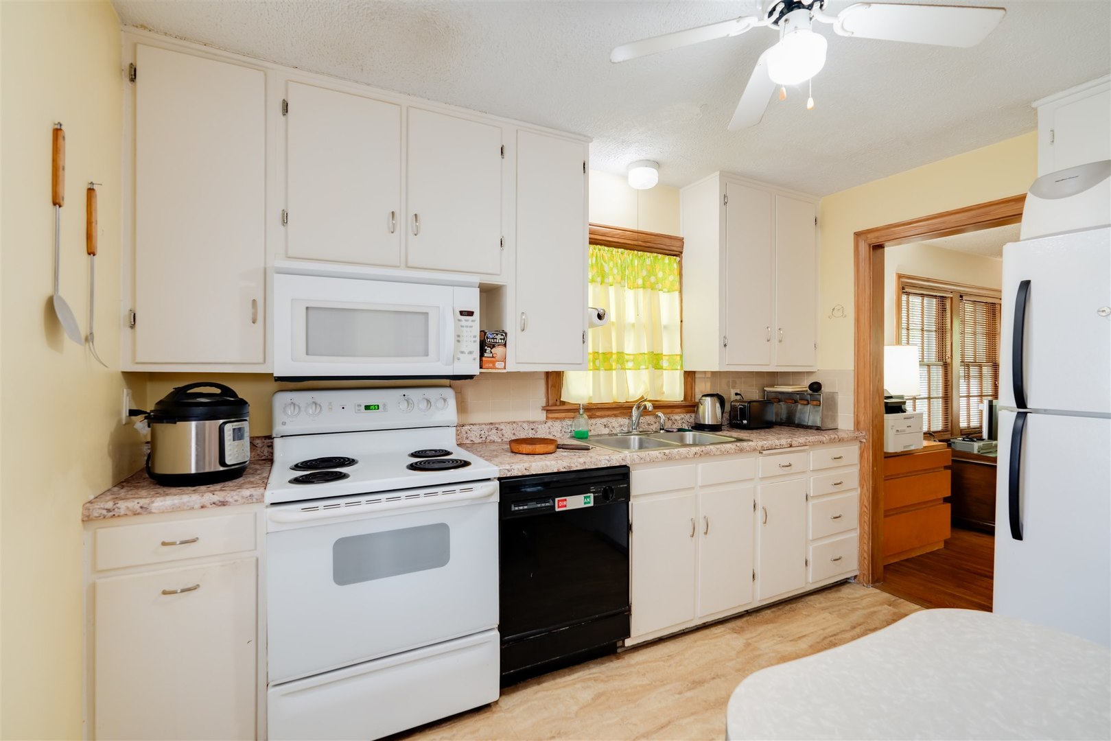 32 White Place Bloomington, IL 61701 - Photo 8 of 26 a kitchen with white cabinets and white appliances