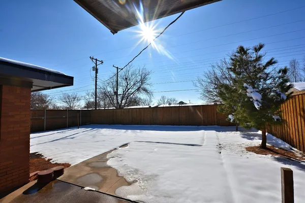 a view of backyard with a patio