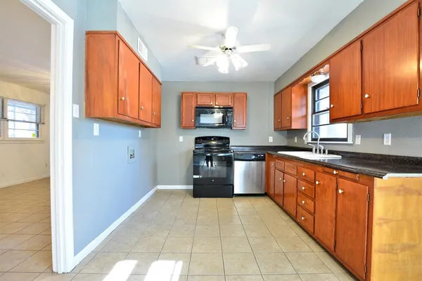 a kitchen with stainless steel appliances granite countertop a stove cabinets and a sink