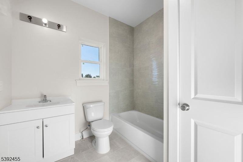 56 Second Street Elizabeth Port, NJ 07206 - Photo 14 of 28 a white toilet sitting next to a bathroom sink