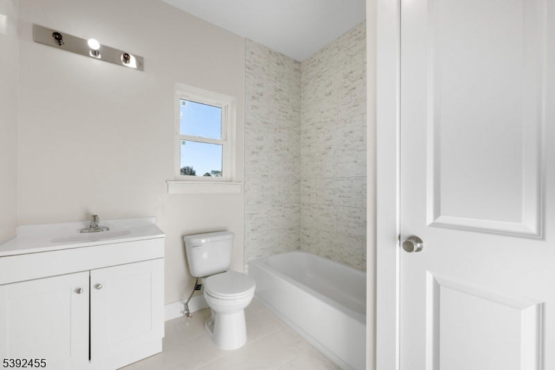 56 Second Street Elizabeth Port, NJ 07206 - Photo 15 of 28 a white toilet sitting next to a bathroom sink