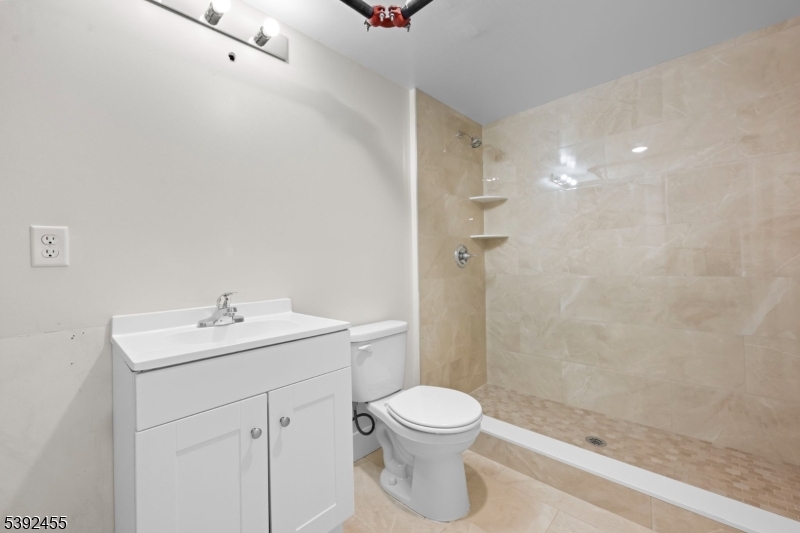 56 Second Street Elizabeth Port, NJ 07206 - Photo 20 of 28 a bathroom with a sink a toilet and shower