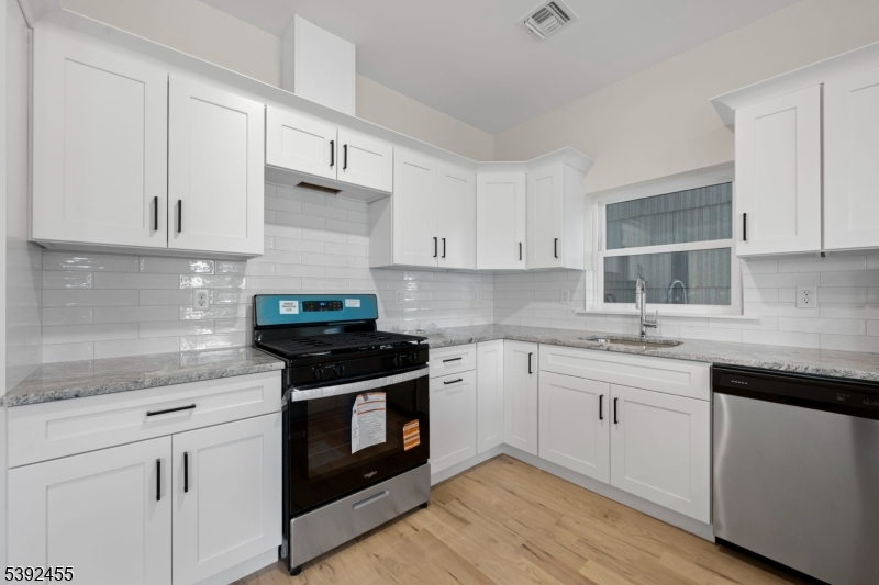56 Second Street Elizabeth Port, NJ 07206 - Photo 26 of 28 a kitchen with cabinets stainless steel appliances and a sink