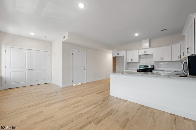 56 Second Street Elizabeth Port, NJ 07206 - Photo 28 of 28 a view of a kitchen with kitchen island stainless steel appliances cabinets a sink and a counter top space