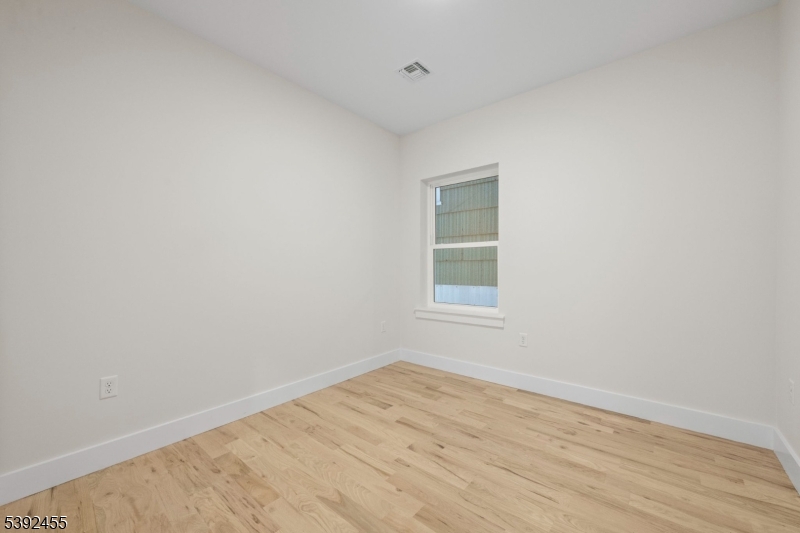 56 Second Street Elizabeth Port, NJ 07206 - Photo 4 of 28 a view of empty room with wooden floor