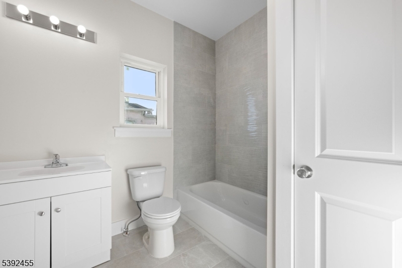 56 Second Street Elizabeth Port, NJ 07206 - Photo 6 of 28 a bathroom with a toilet a sink and a bathtub