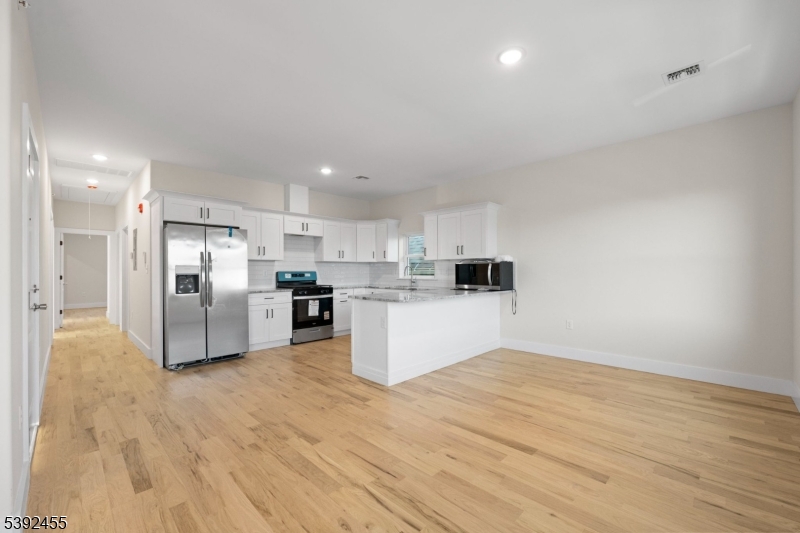 56 Second Street Elizabeth Port, NJ 07206 - Photo 10 of 28 a kitchen with stainless steel appliances kitchen island sink refrigerator and cabinets