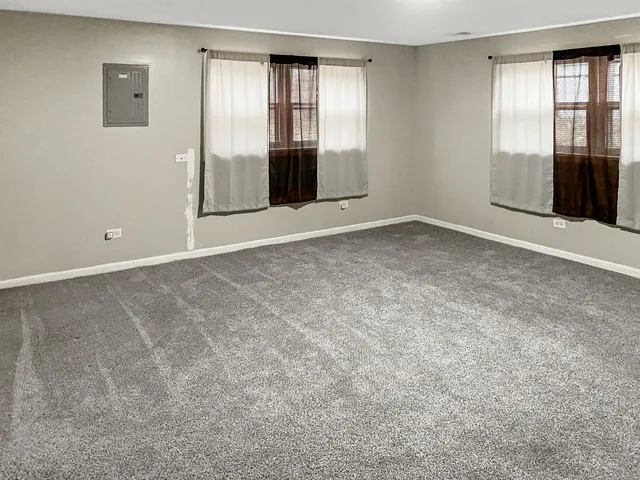 an empty room with windows and closet