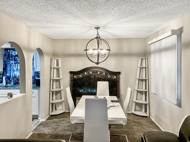 a living room with furniture a rug and white walls