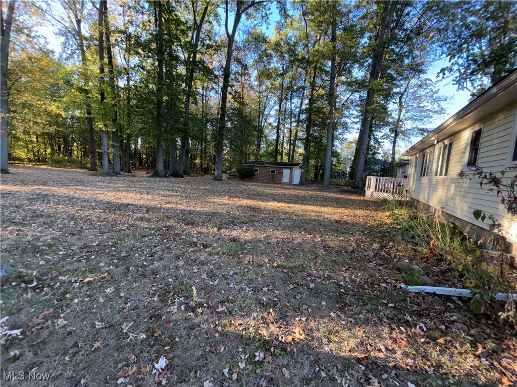 1900 Jaycox Road Avon, OH 44011 - Photo 25 of 26 View of yard featuring a wooden deck and an outdoor structure