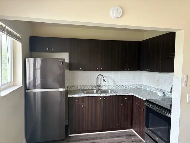 a kitchen with a sink and a refrigerator