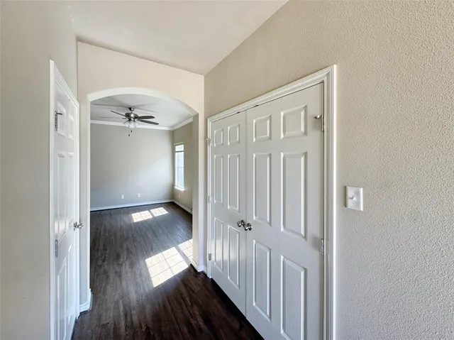 a kitchen with stainless steel appliances granite countertop a refrigerator a stove top oven a sink and dishwasher with wooden floor